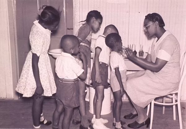 Children with a teacher, 1960s